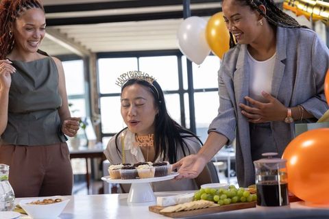 Coworkers Celebrating Birthday at Office with Cupcakes and Balloons