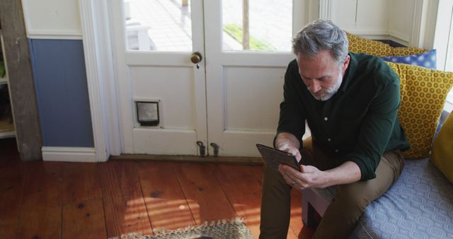 Mature Man Reading a Tablet on a Cozy Home Sofa - Download Free Stock Images Pikwizard.com