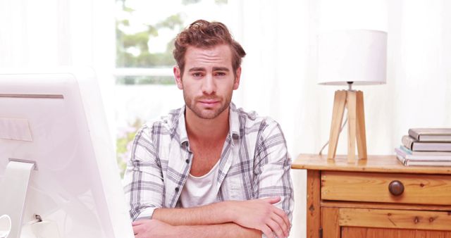 Frustrated Man Sitting at Desk Facing Work Challenges - Download Free Stock Images Pikwizard.com