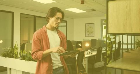 Young Professional with Tablet in Modern Minimalist Office