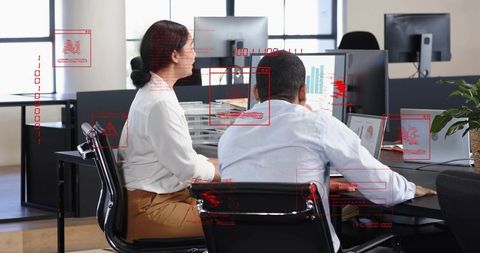 Reviewing analytics dashboards together in modern office with red HUD overlays