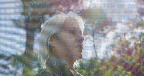 Elderly woman in park with binary code overlay symbolizing technological enlightenment