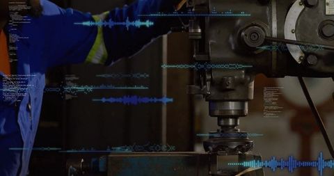 Industrial machinist adjusting milling machine with code overlays