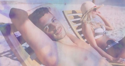 Relaxed Couple Sunbathing on Tropical Beach Loungers