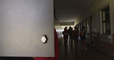 Child Opening School Locker in Busy Hallway