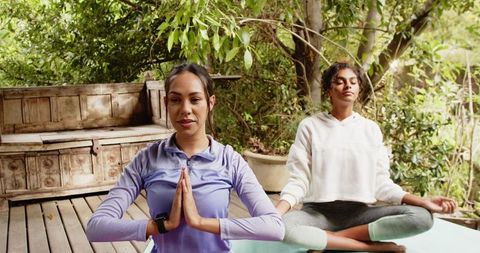 Diverse Friends Engaging in Yoga Practice on Outdoor Deck