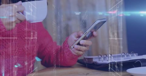 Woman in red sweater browsing smartphone at cozy cafe