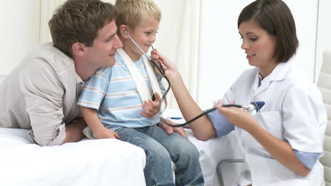 Pediatric Check-Up Little Boy with Doctor and Father Present