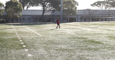 Soccer Player Preparing for Morning Practice on Field