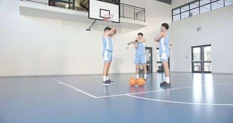 Male Teammates Preparing in Lap Blue Kits, Gym Court