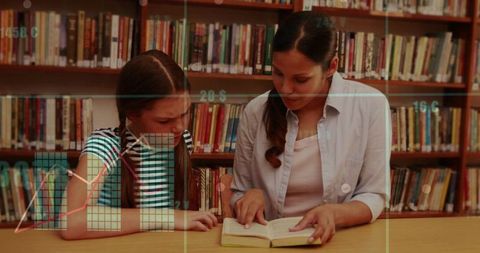Tutor Guiding Student Through Book at School Library Table, Reading Tutoring and Mentoring
