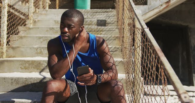 Tired Athlete Listening to Music on Urban Staircase After Workout - Download Free Stock Images Pikwizard.com