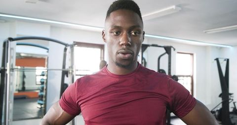 Determined Athlete Resting in Modern Gym Environment