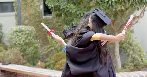 Graduates Celebrating Achievement with Joyful Hugs - Download Free Stock Images Pikwizard.com