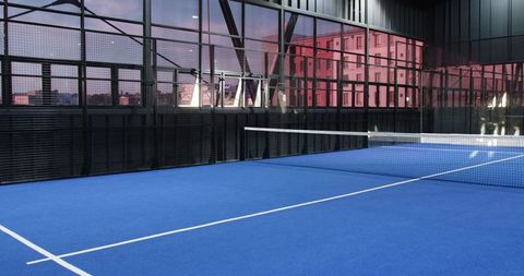 Modern Indoor Tennis Court with Blue Surface in Urban Area