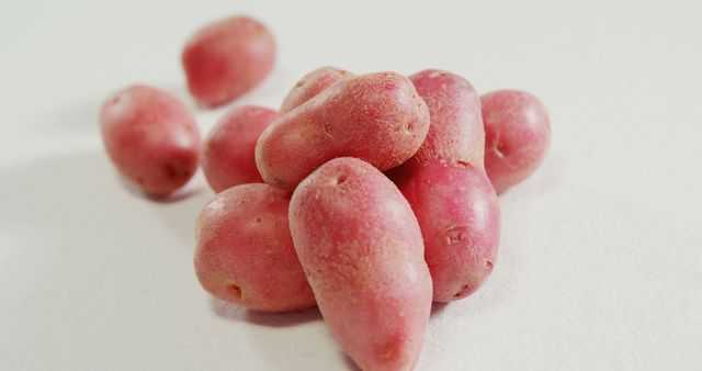 Close up of fresh red potatoes lying on white background. Health, diet, vegetables and food.
