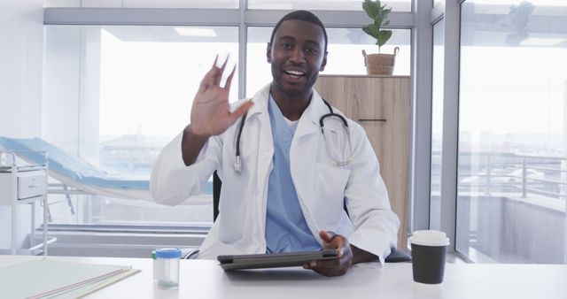 Friendly African American Doctor Waving During Online Consultation - Download Free Stock Images Pikwizard.com