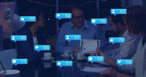 Executive Team Analyzing Social Media Engagement and Analytics on Tablet During Night Meeting