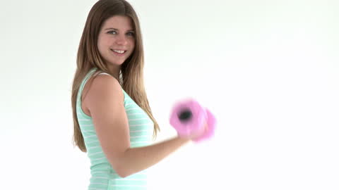 Teenager Smiling While Exercising with Dumbbells