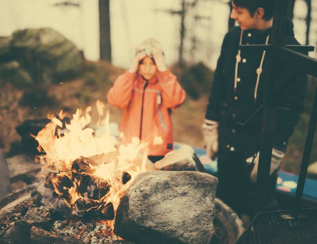 Family Enjoying Campfire in Forest During Autumn Evening - Download Free Stock Images Pikwizard.com