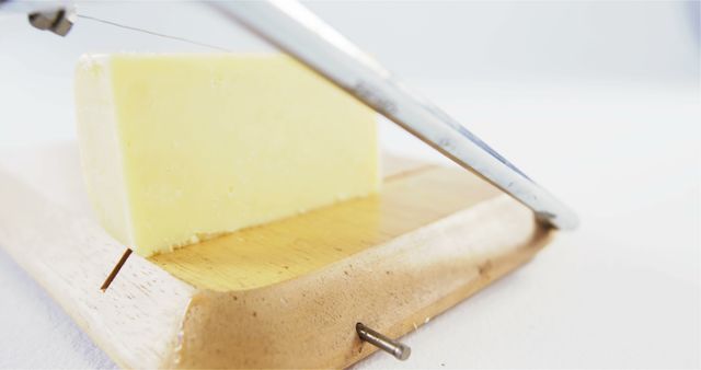 Cutting Cheese with Cheese Slicer on Wooden Board - Download Free Stock Images Pikwizard.com