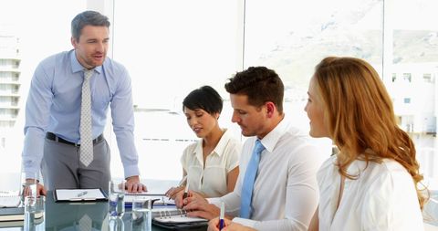 Businessman Leading Team Meeting in Modern Office - Download Free Stock Images Pikwizard.com