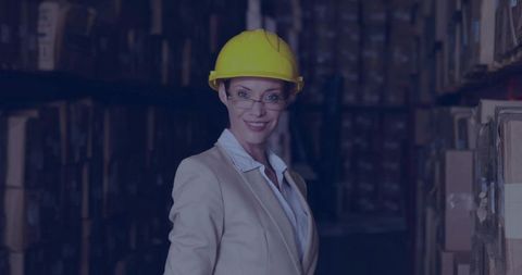 Professional woman in safety gear supervising warehouse