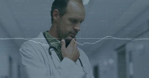 Contemplative Doctor in Hospital Corridor Analyzing Data