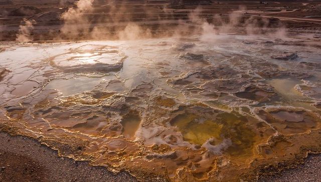 Geothermal travertine terraces emitting steaming vents
