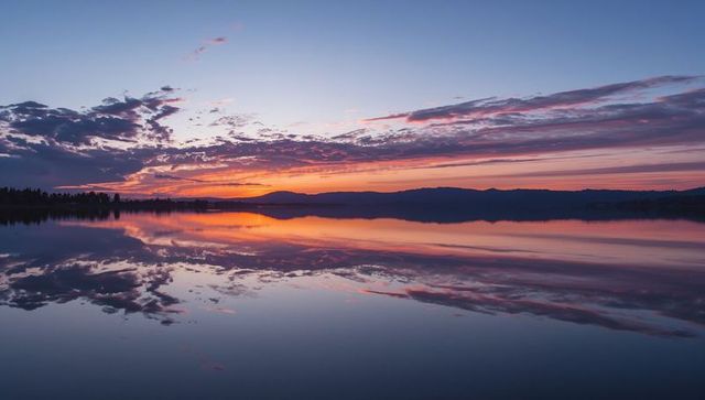 Serene sunset reflections on tranquil lake