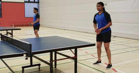 Diverse Team Practicing Table Tennis in Gym