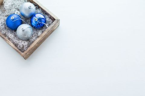Blue and silver christmas baubles in wooden box