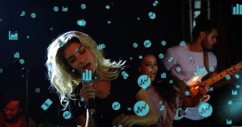 Blonde lead singer performing with band on dark stage with floating data icons
