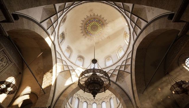 Sunbeams illuminating ornate dome with stained-glass rosette and hanging chandelier