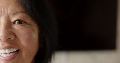 Senior Asian Woman Smiling Indoors Highlighting Happy Lifestyle