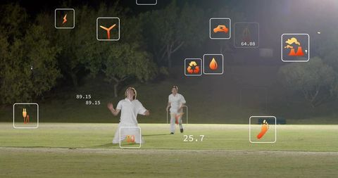 Floodlit night cricket celebration with augmented reality performance icons on grass