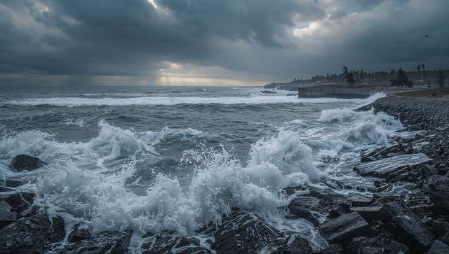 Stormy Ocean Waves Crashing on Rocky Seawall Under Moody Sky