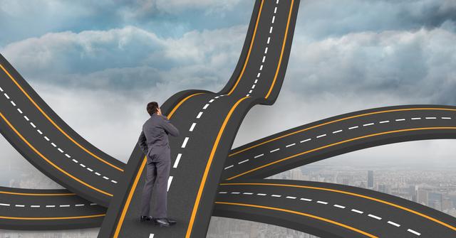 A businessman stands on a network of wavy roads, symbolizing career choices and decisions. This can be used in articles or presentations about career paths, business challenges, decision-making, and professional development.