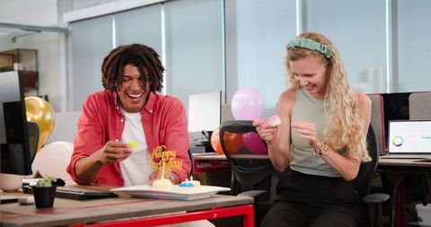 Coworkers Celebrating Birthday at Office Desk with Cupcakes