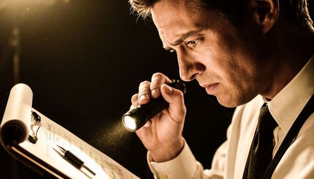 Intense detective inspecting clipboard with flashlight under dramatic chiaroscuro lighting