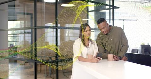 Coworkers leaning at break counter checking smartphone with abstract data overlay