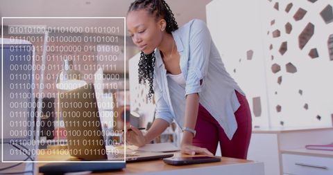 Biracial Businesswoman Engaging in Data Processing in Modern Office