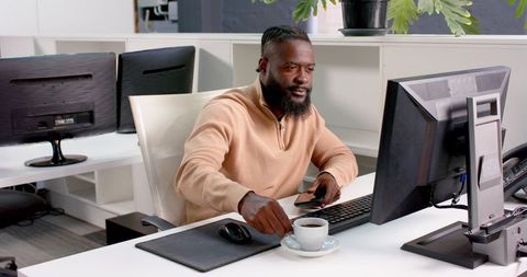 African American Man Working with Coffee in Modern Office