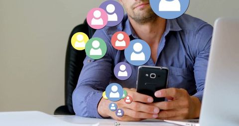 Office worker using smartphone with digital network icons