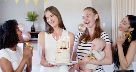 Diverse Friends Celebrating 30th Birthday with Cake and Baby