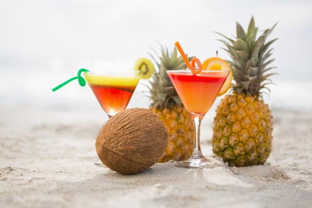 Tropical Cocktails with Pineapples and Coconut on Beach - Download Free Stock Photos Pikwizard.com