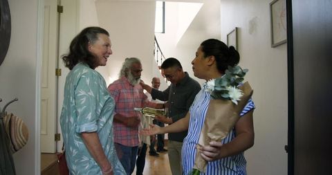 Diverse Friends Arriving with Gifts for Home Celebration