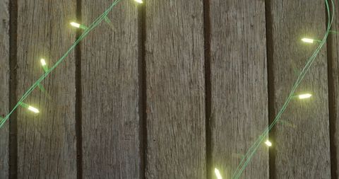 Fairy Lights Illuminating Wooden Texture Background