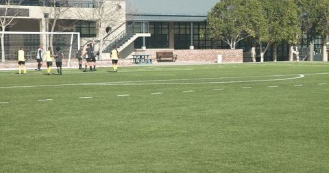 Group of Soccer Players Practicing on School Field - Download Free Stock Images Pikwizard.com
