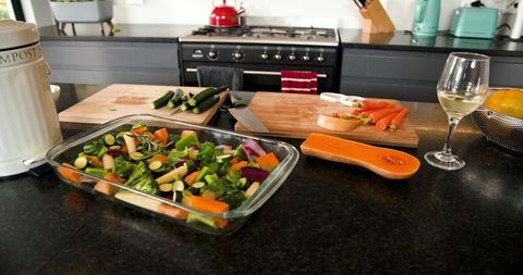 Preparing Fresh Vegetables for Gourmet Cooking on Modern Kitchen Counter